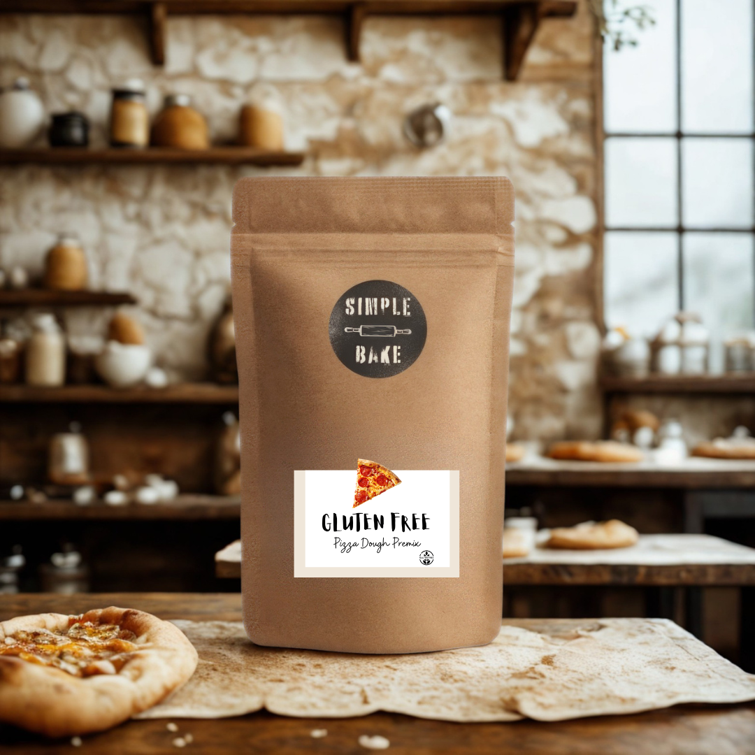 Brown package of gluten-free pizza dough mix with a label on a wooden table in a rustic kitchen setting.