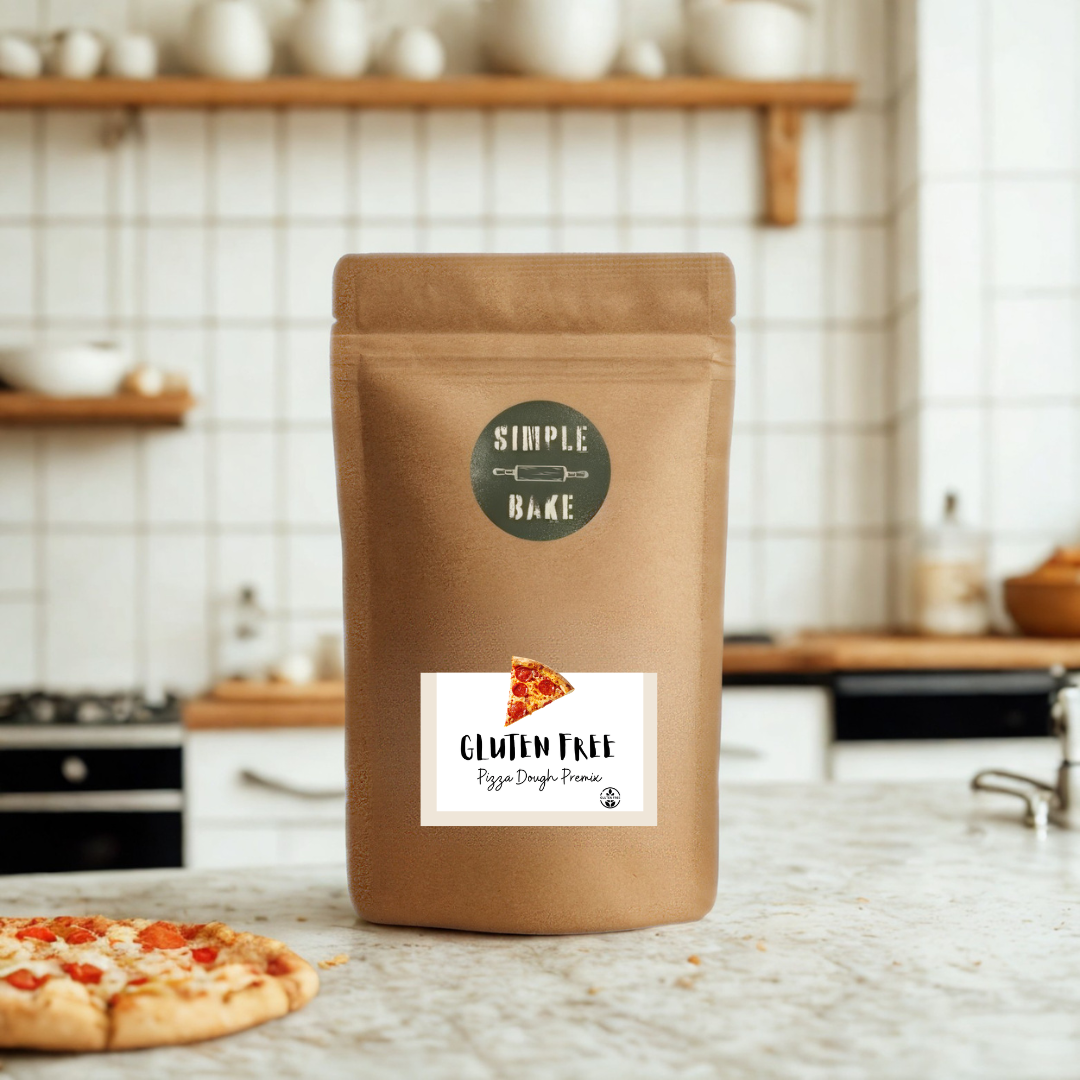 Bag of gluten-free pizza dough mix with a pizza on a kitchen counter